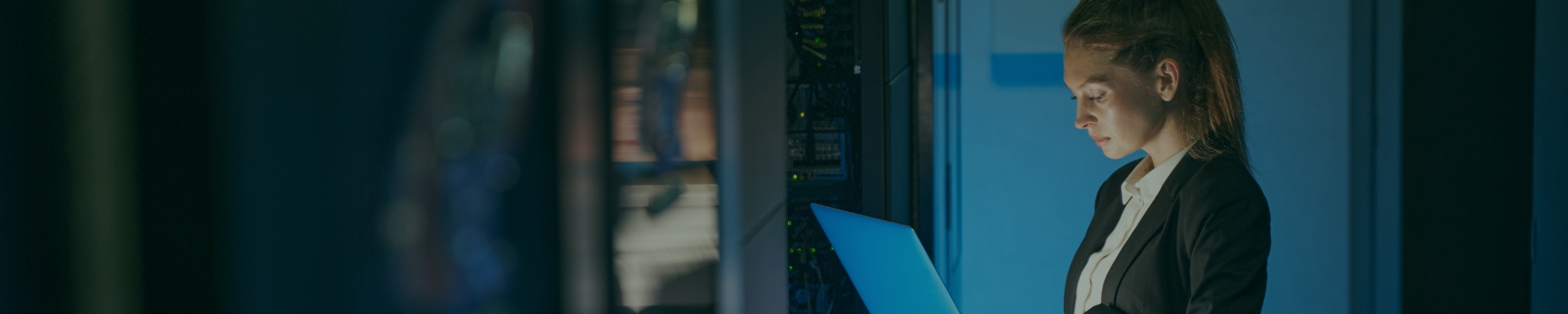 Woman at mainframe in dark